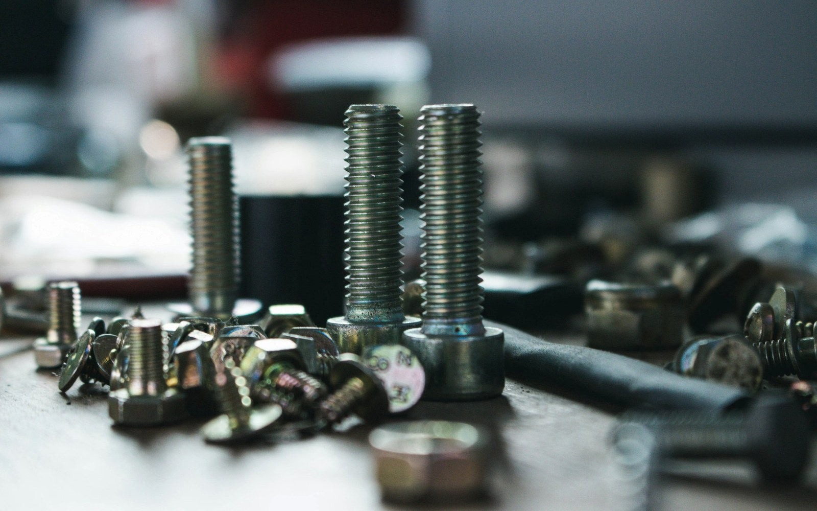 Stainless steel nuts, bolts and screws on a workbench for A2 and A4 grade comparison